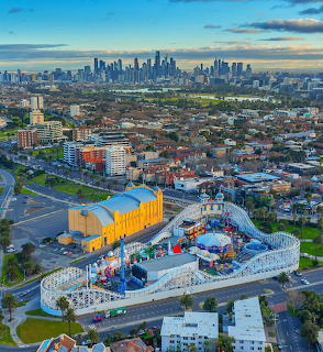 Aerial view of Melbourne skyline from St Kilda with Luna Park in foreground and city buildings in distance