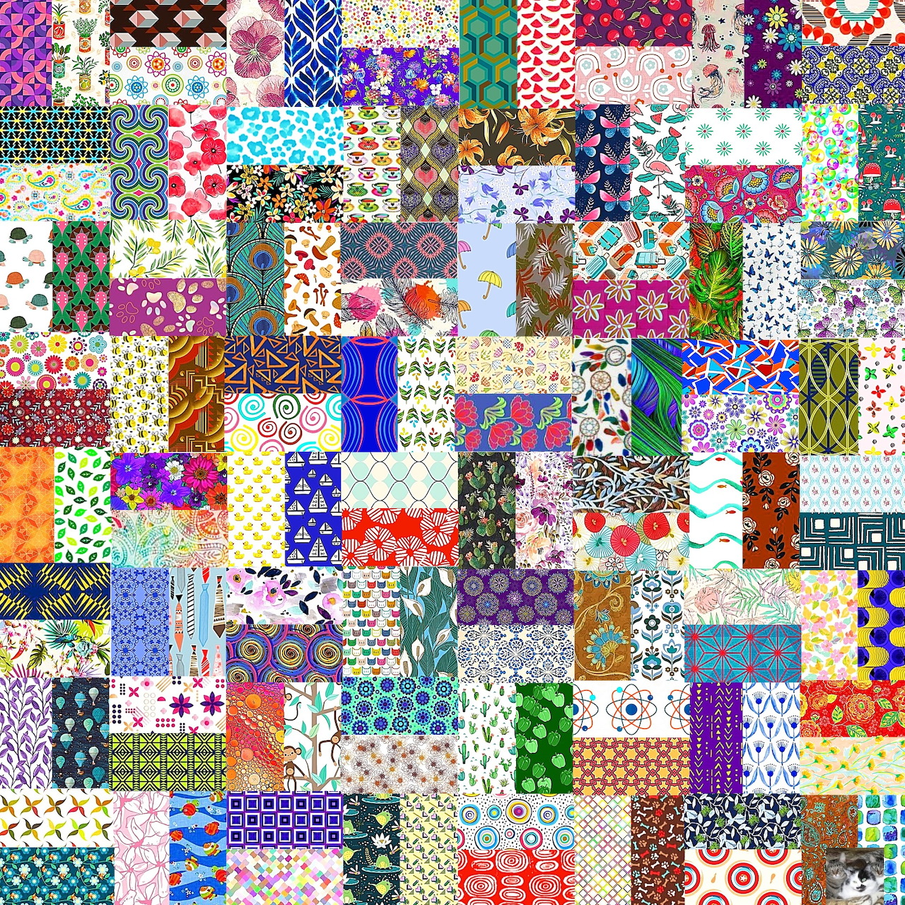 Colorful patchwork quilt with many different fabric patterns and designs arranged in a grid layout