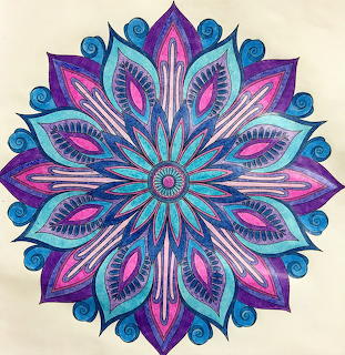 Blue and pink symmetrical mandala illustration on a beige background