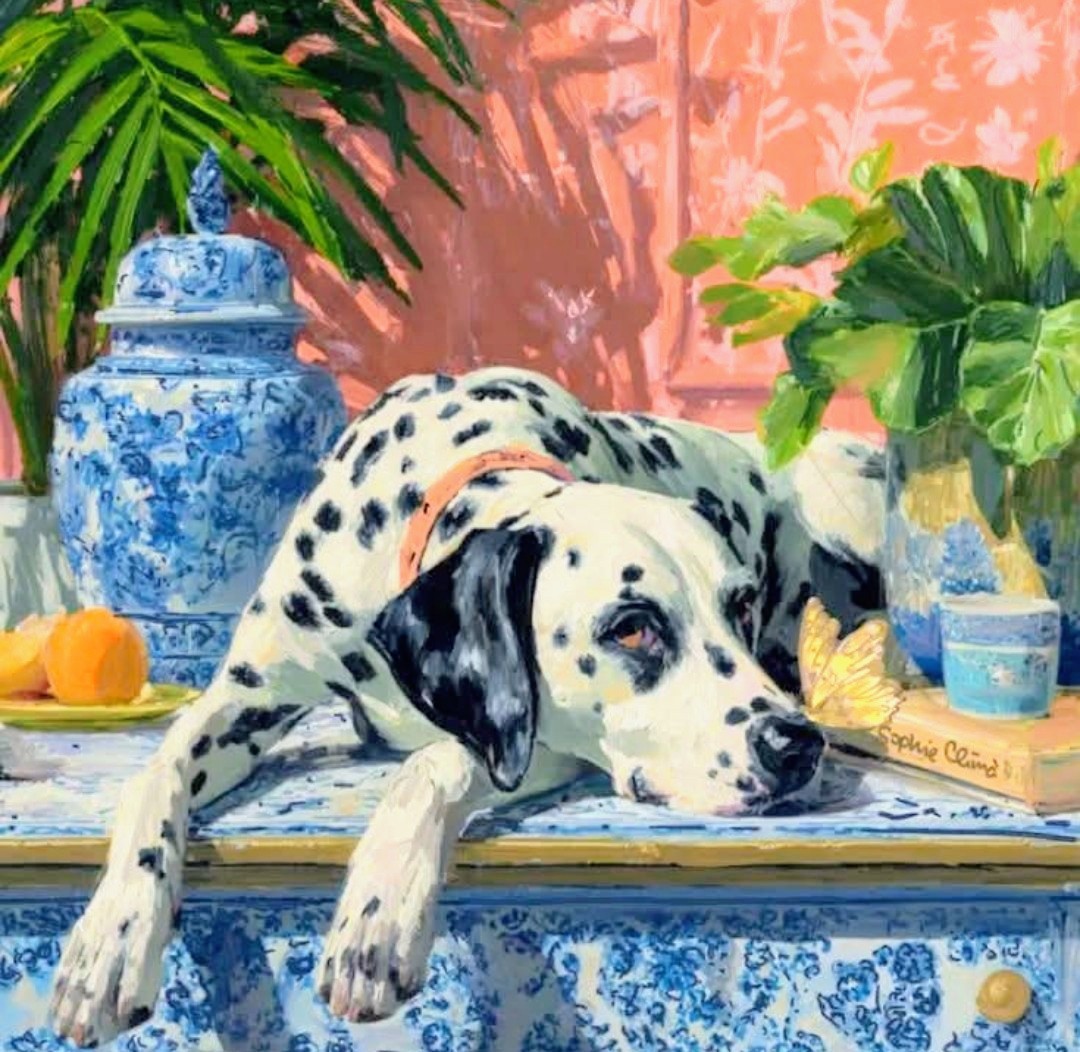 Dalmatian dog lying on blue and white ceramic table with tropical plants and ginger jars in background