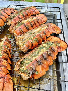 Grilled lobster tails with herb butter on wire cooling rack