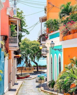 Narrow cobblestone street lined with colorful colonial buildings in Old San Juan, Puerto Rico