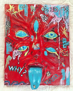 Abstract red face with turquoise eyes and protruding tongue on textured collage background