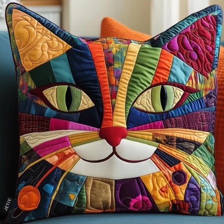Quilted decorative pillow shaped like a cat face with rainbow patchwork fabric and green button eyes