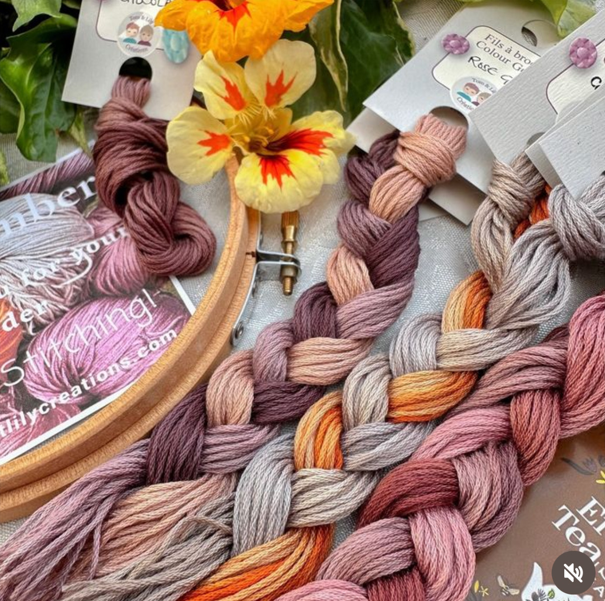 Embroidery threads in various colors with yellow flower and wooden hoop