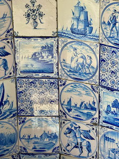 Blue and white Portuguese azulejo tiles with scenic paintings and decorative patterns