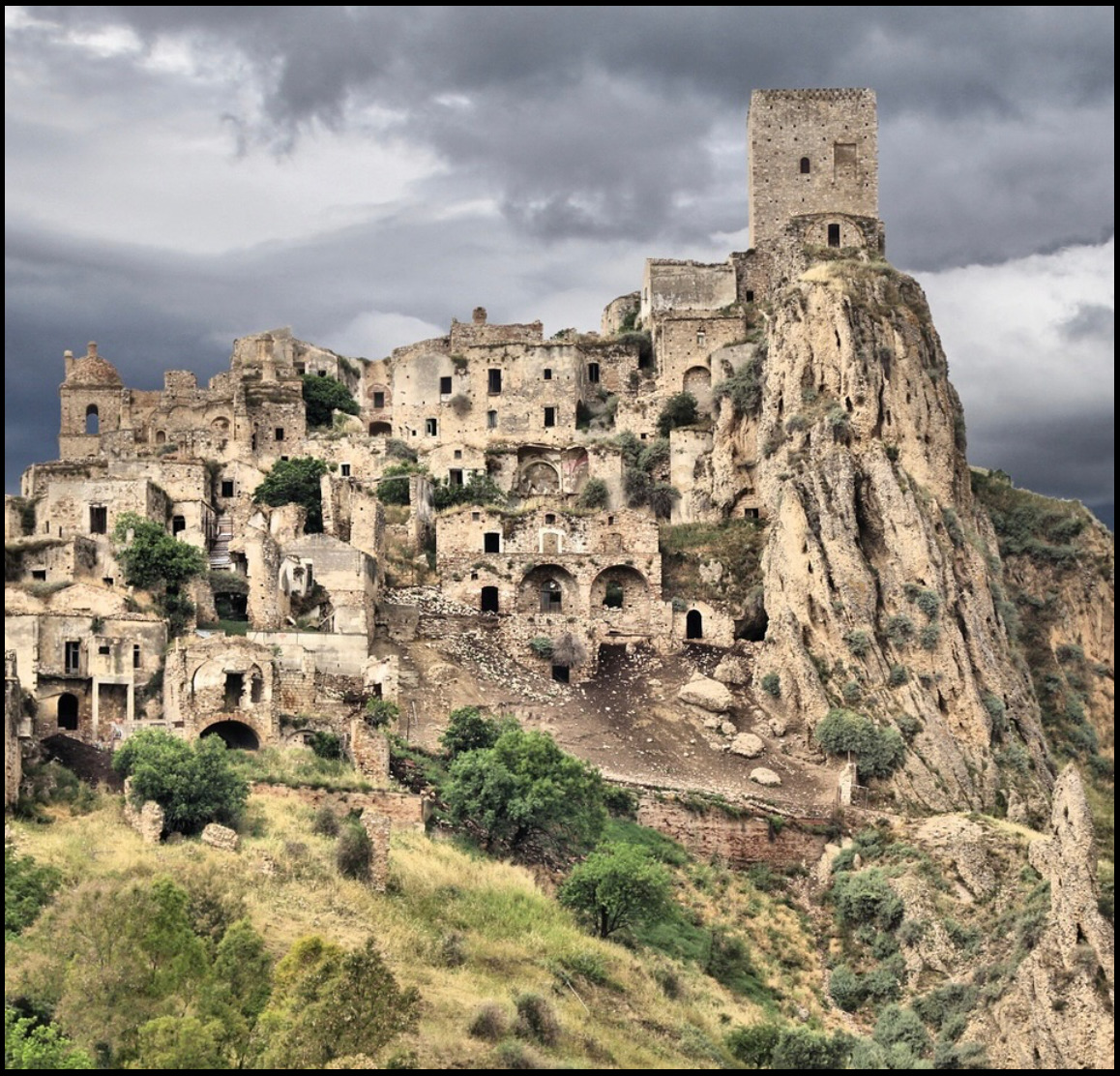 Craco abandoned medieval village on cliff in Italy under stormy sky