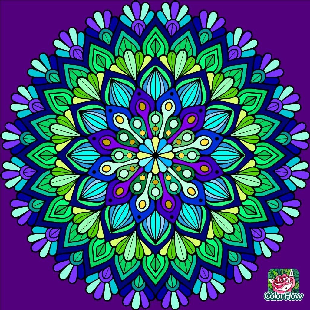 Colorful symmetrical mandala with geometric floral petals in blue, green, and purple tones on purple background