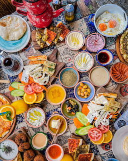 Overhead view of a large traditional Turkish breakfast spread with many colorful dishes and foods