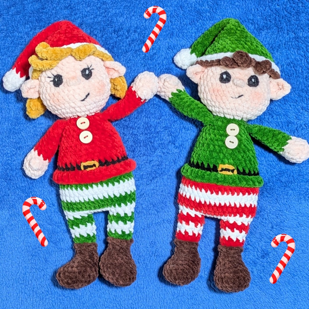 Two crocheted Christmas elf dolls in festive red and green outfits with candy canes on blue background