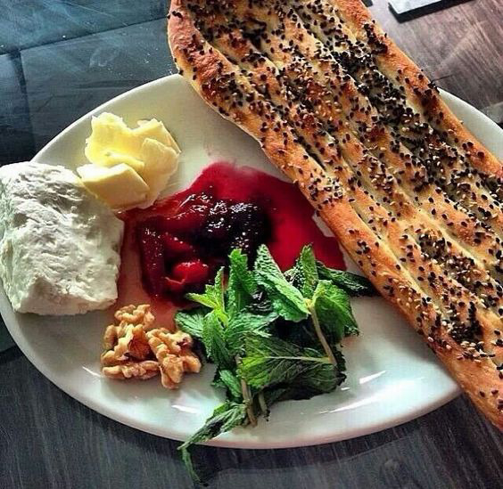 Sesame crusted salmon fillet plated with butter, cream cheese, beetroot, walnuts and greens