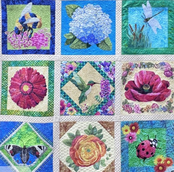 Patchwork quilt with nine squares showing floral and garden designs in bright colors