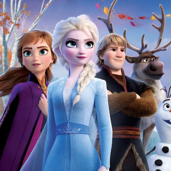 Elsa, Anna, Kristoff, Sven, and Olaf from Frozen 2 standing together outdoors