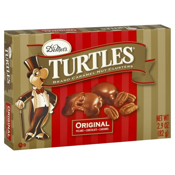 Box of chocolate turtle candy with caramel, pecan, and chocolate shown on the packaging