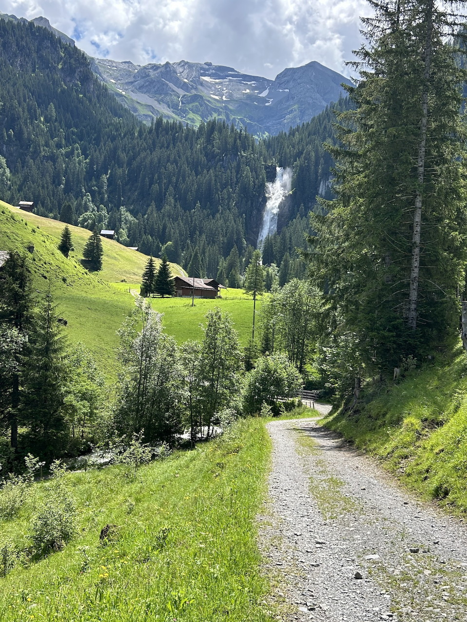 Iffigenfälle waterfall cascading down rocky cliffs amid alpine vegetation