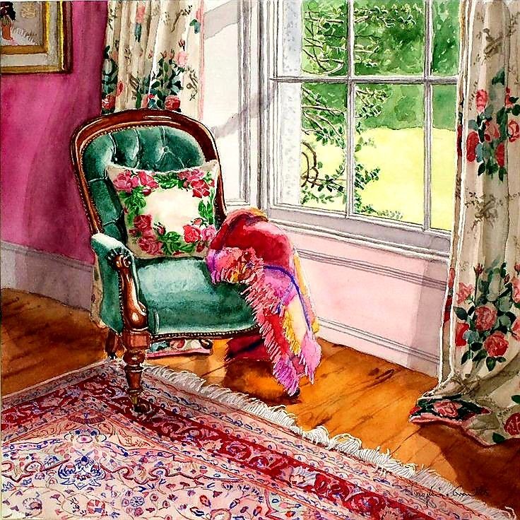 Teal armchair with floral cushion by window with garden view, colorful throw blanket and patterned rug