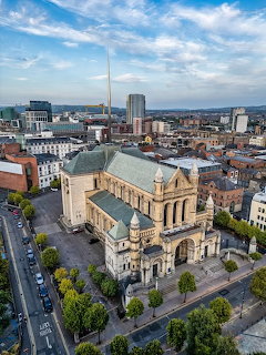 Aerial view of St Anne's Cathedral in Belfast with surrounding city buildings and streets