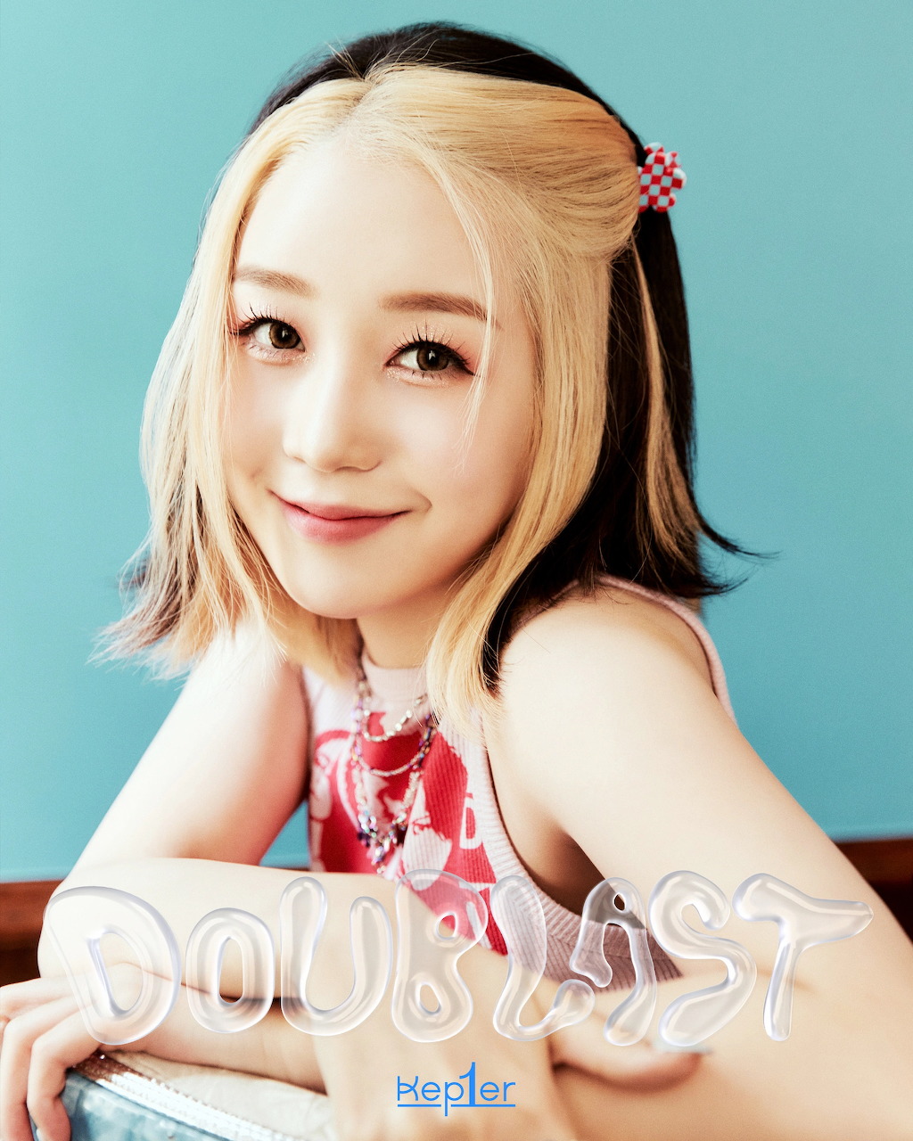 Young woman with styled hair posing for a K-pop promotional portrait