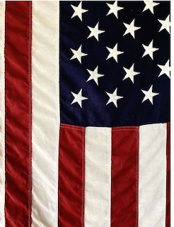 Close-up of American flag with stars and stripes showing fabric texture