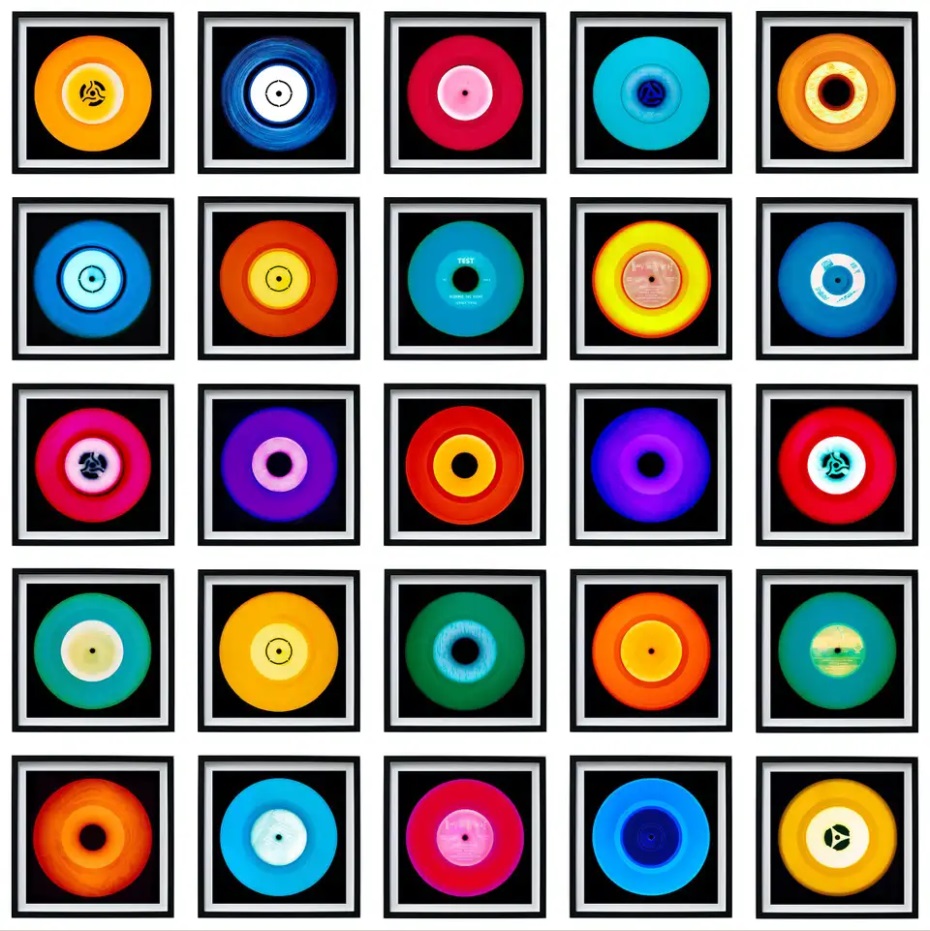 Grid of 25 colorful vinyl records in individual square frames against black backgrounds