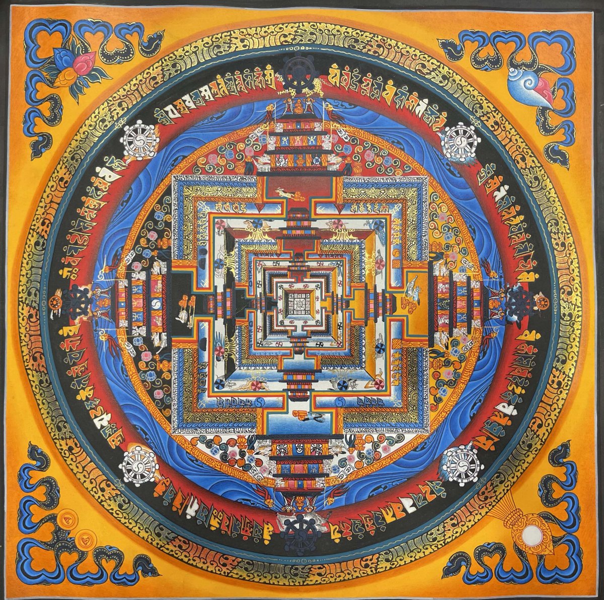 Colorful Kalachakra mandala with ornate concentric circles and geometric patterns on orange background
