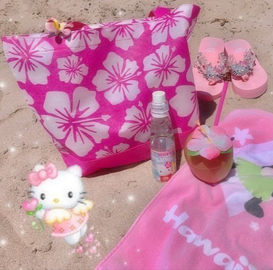 Hello Kitty beach scene with pink pillow, flip-flops, bottle, coconut drink, and towel on sand