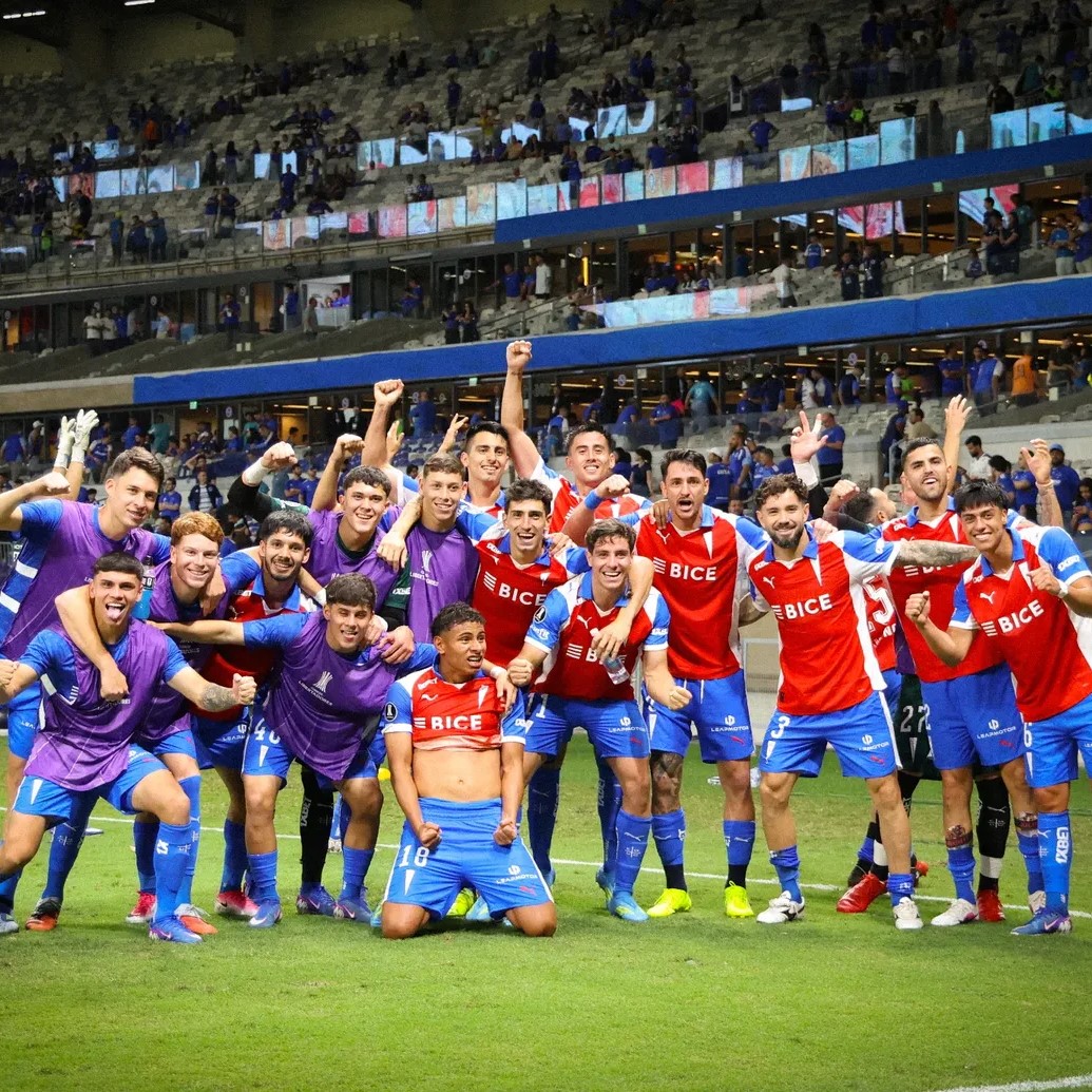 Universidad Católica soccer team celebrating on the field in a stadium