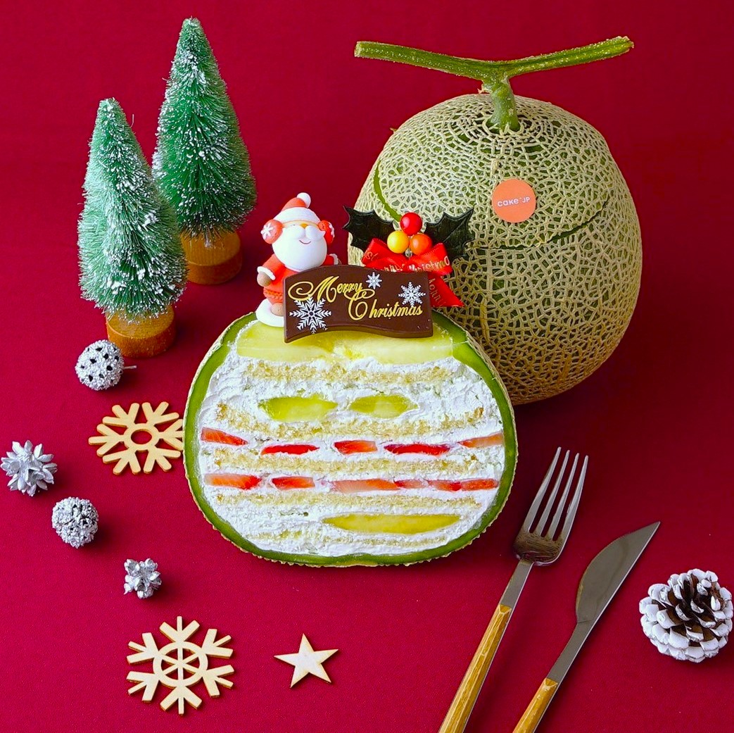 Sliced Christmas layer cake with festive decorations on a red background