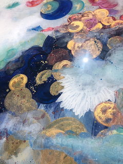 Abstract fluid art with gold leaf, deep blue, white and turquoise swirling organic shapes