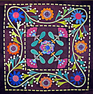 Colorful symmetrical folk art pattern with central mandala and floral border on purple background