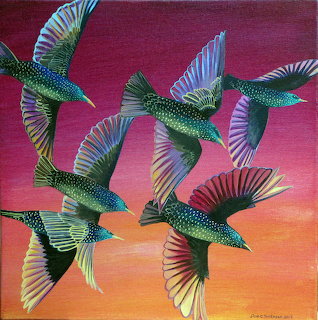 Five colorful starlings flying against a red-orange sunset gradient sky with spread wings showing iridescent feathers