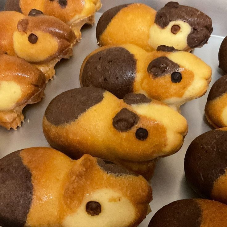 Close-up of hamster-shaped cakes with chocolate accents on a tray