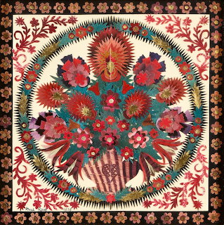 Intricate paper-cut floral bouquet with decorative border in folk art style