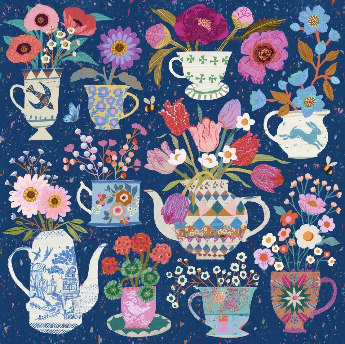 Colorful flowers in decorative white teacups and teapots on dark blue background