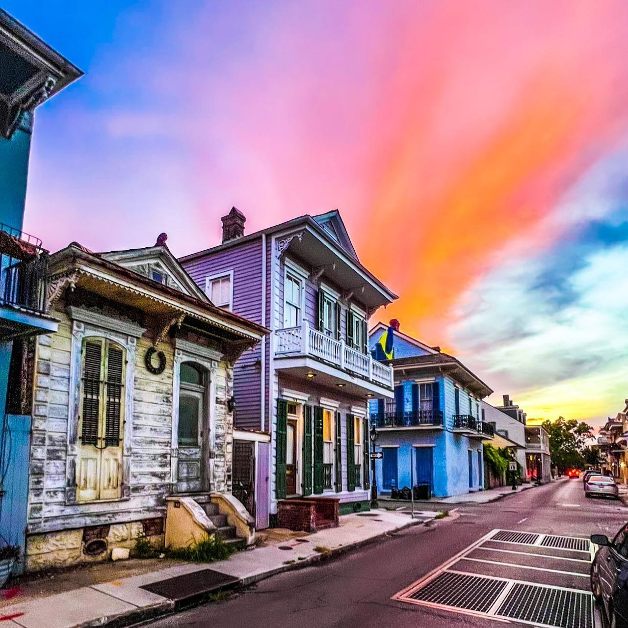Colorful historic houses on a New Orleans street at sunset with vibrant orange and blue sky