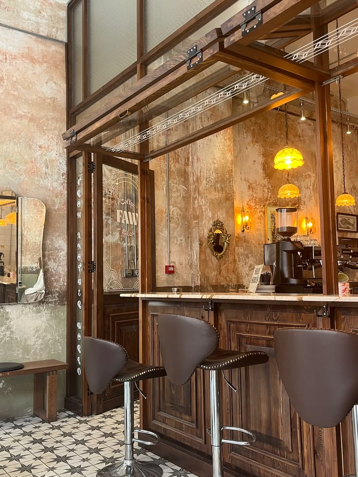 Modern café interior with bar counter, stools, wooden beams, and pendant lights