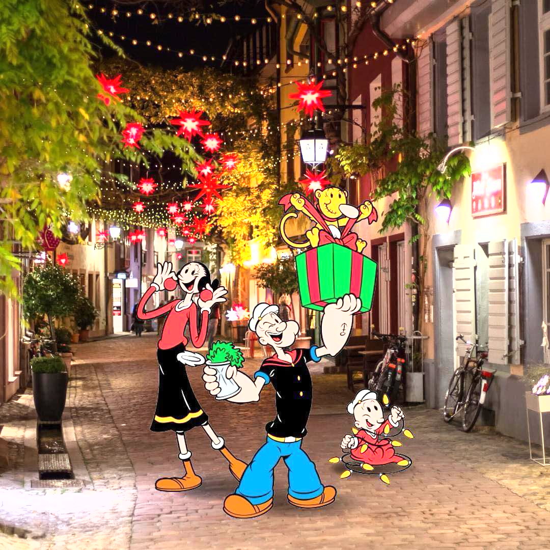 Popeye and cartoon characters on a festively lit Christmas street with colorful decorations
