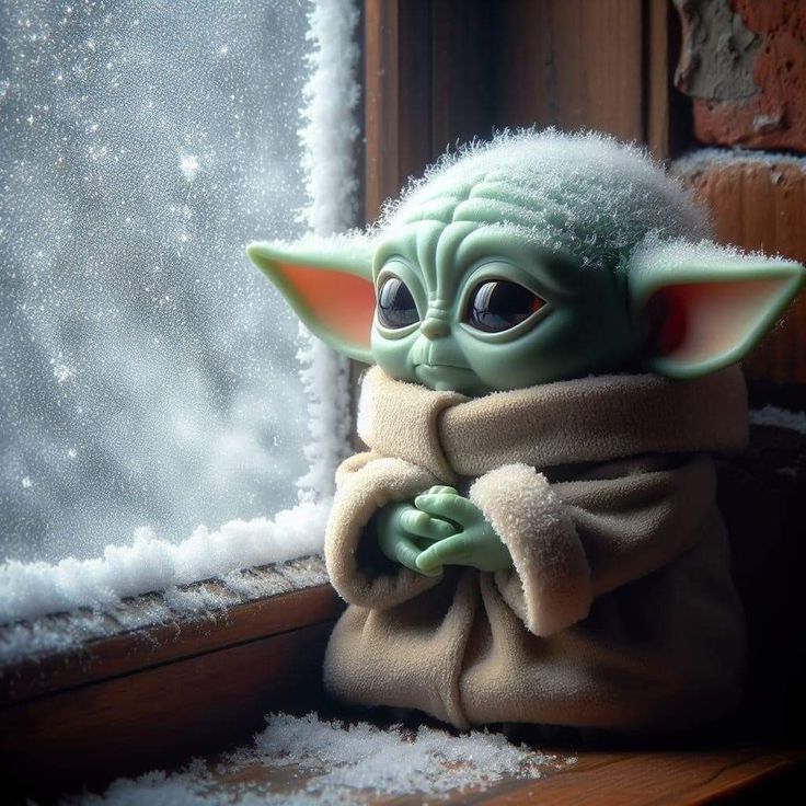 Baby Grogu sitting by a snowy window looking sad and lonely in winter