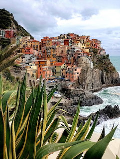 Colorful hillside village of Manarola in Cinque Terre, Italy, on rocky cliffs above the Mediterranean Sea