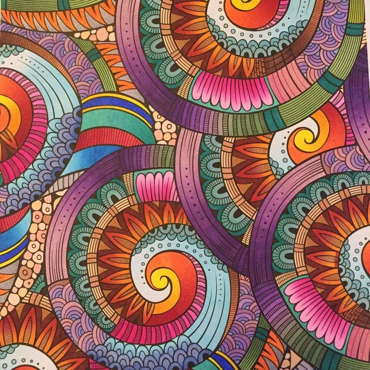 Vibrant decorative pattern featuring multiple spiral swirls with concentric colored bands and ornate details