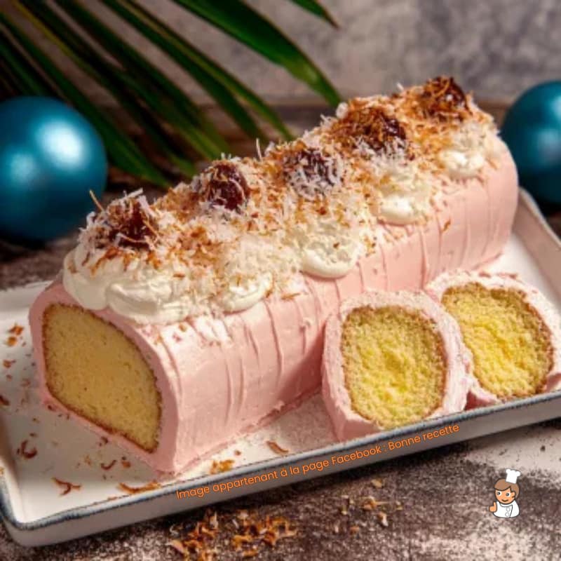 Pink frosted yule log cake with white meringue swirls on top, slice showing yellow sponge cake