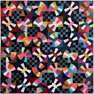 Colorful geometric quilt with circular patterns and checkered background in vibrant multi-colored fabric pieces