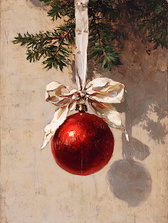 Red Christmas ornament with cream ribbon bow hanging from evergreen branch against beige wall