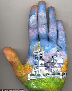 Hand painted with a landscape scene featuring white church buildings, green grass, and a blue sky.