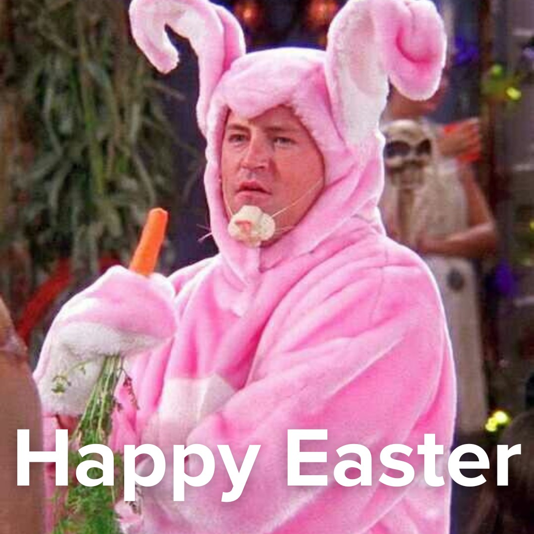 Man in a pink bunny costume holding a carrot with Happy Easter text