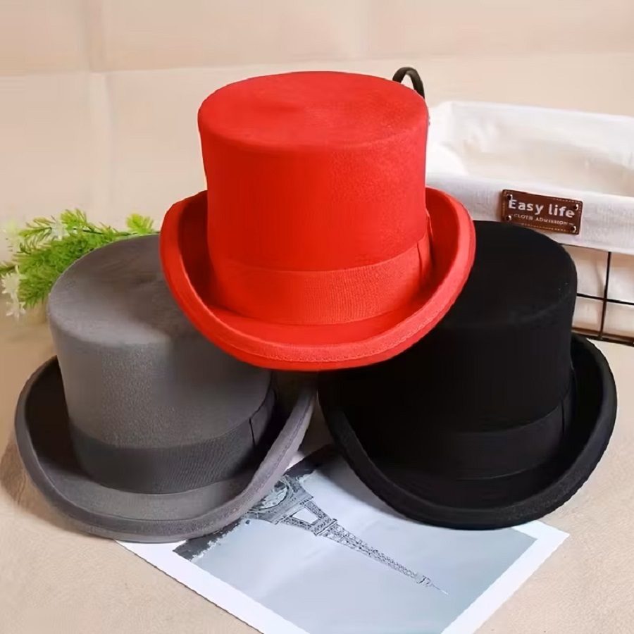 Four top hats in red, gray, and black colors arranged together on white surface