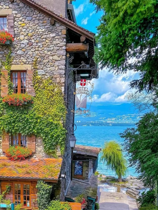 Ivy-covered stone house by a lakeside lane in Yvoire, France
