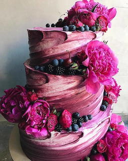 Three-tier purple ombre cake with blackberries, raspberries, and pink peonies