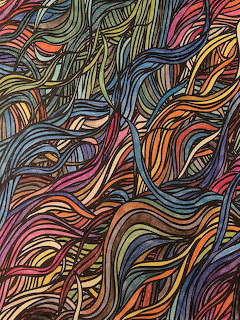 Colorful hand-drawn abstract doodle with flowing wavy lines in blue, orange, green, purple, and red