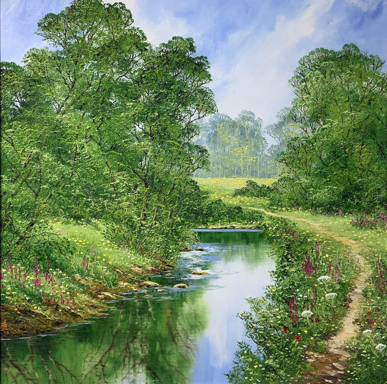 Peaceful river winding through green summer countryside with trees and rainbow in sky
